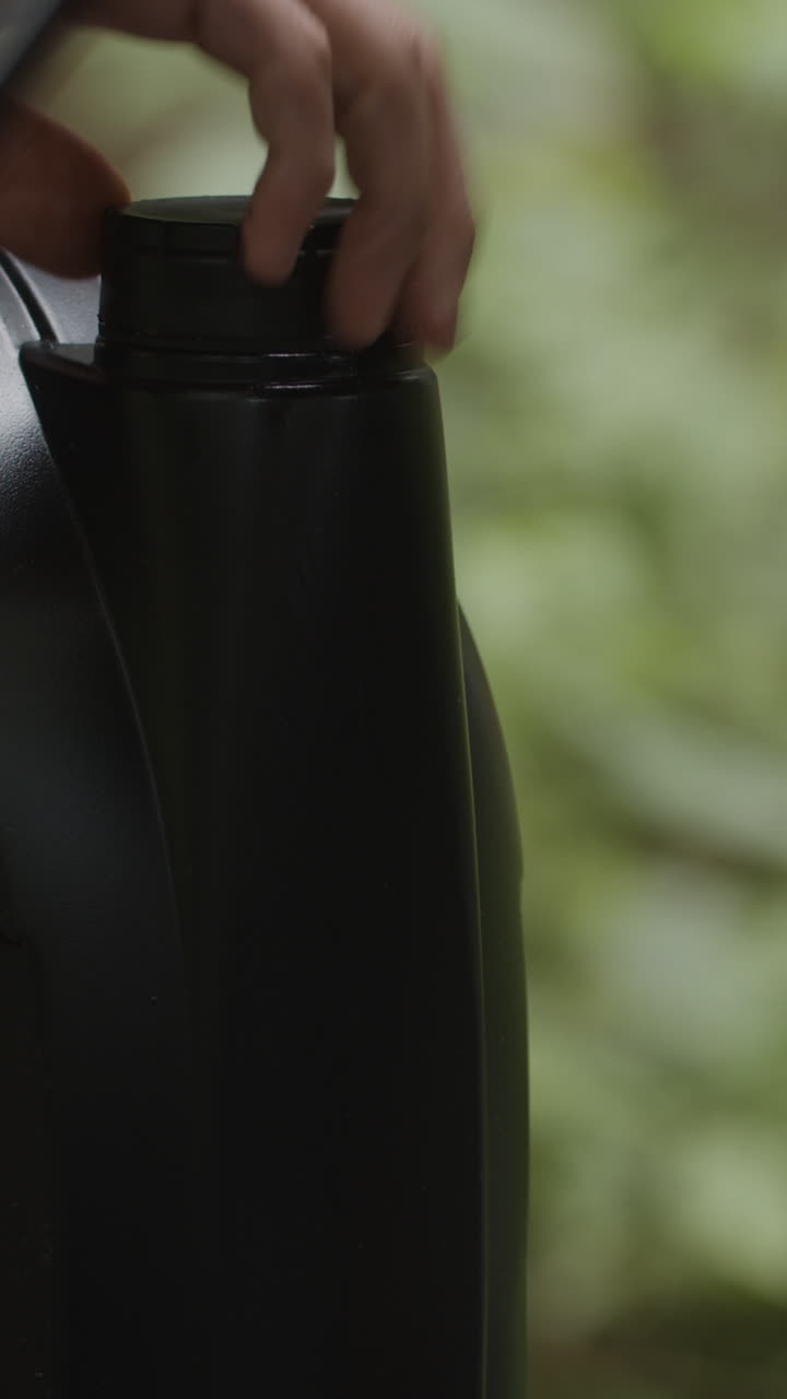 Black jug with person's hand