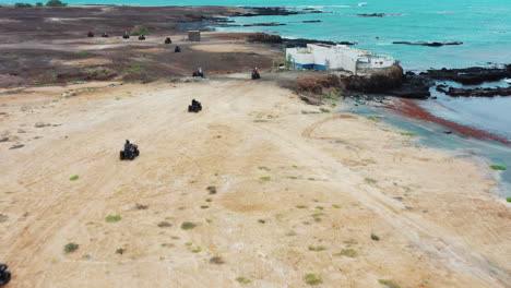 Aerial-shot-of-quad-bikes-driving-through-the-rough-terrain,-during-an-off-road-adventure