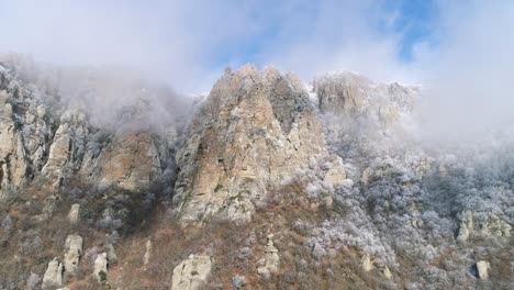 snowy mountain peaks with fog