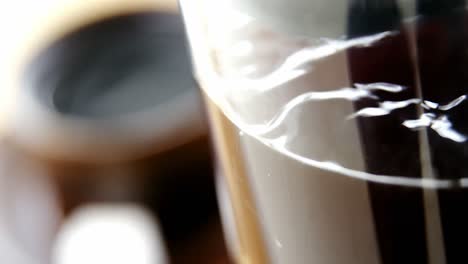 Cafetiere-and-a-cup-of-black-coffee-on-table