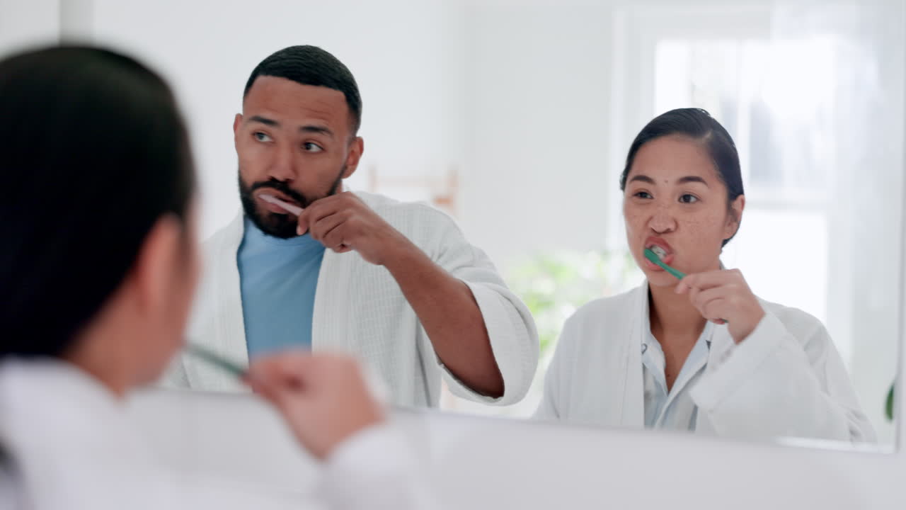Bathroom, mirror and couple brushing teeth