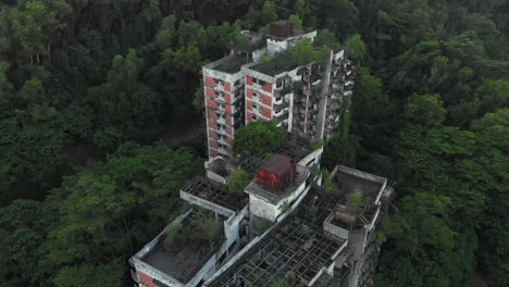 abandoned highland towers in lush green vegetation at kuala lumpur, aerial