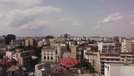 Pan-up-drone-shot-of-the-Bucharest-skyline-on-a-hot-summer-day