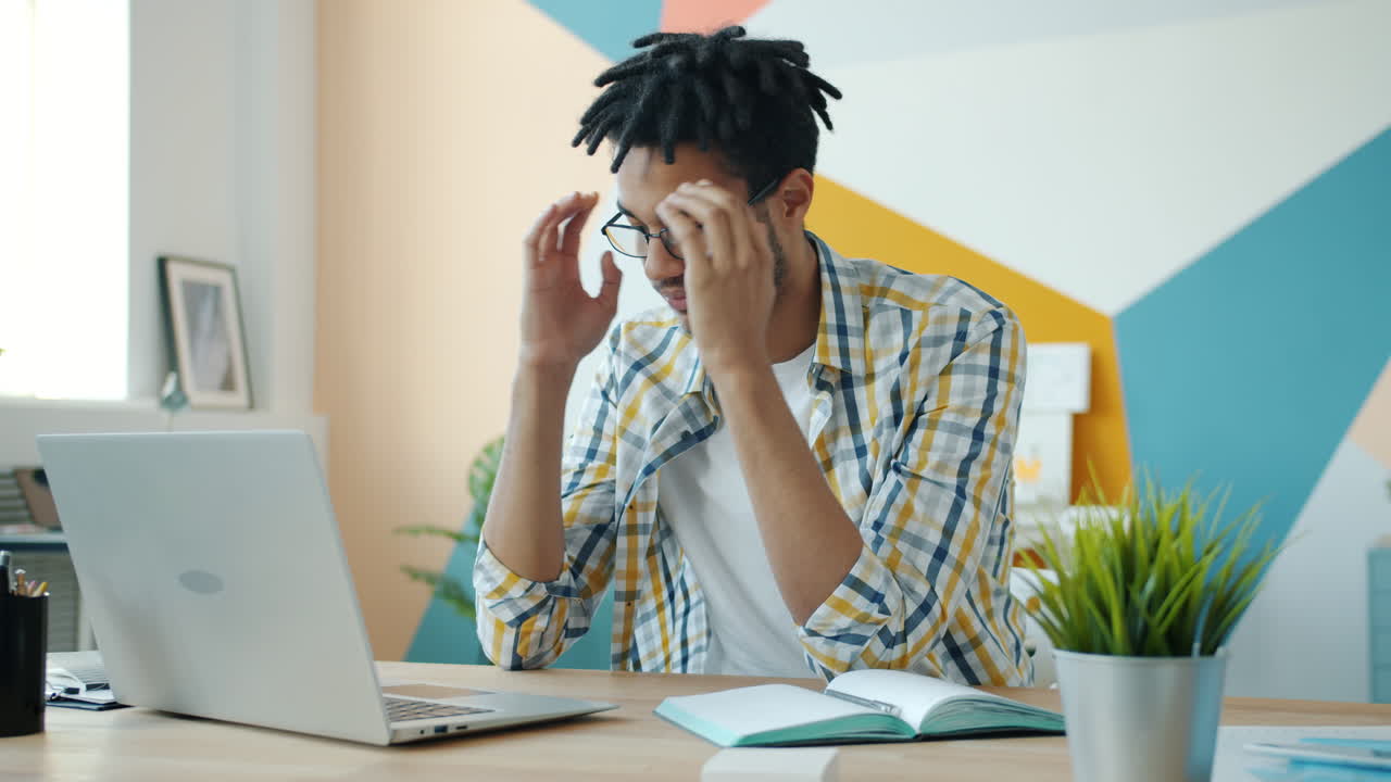 Young Man Working on Laptop in Office