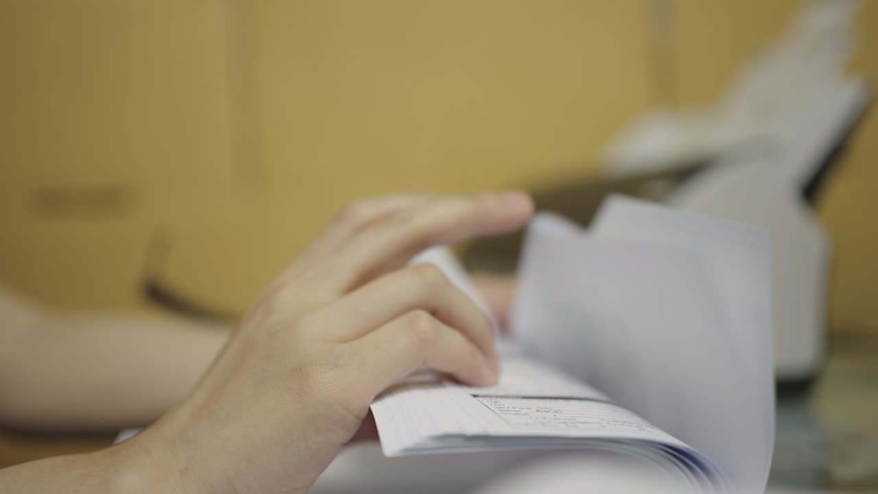 Close-up, Hand of woman is counting sheets of paper or documents in the office.