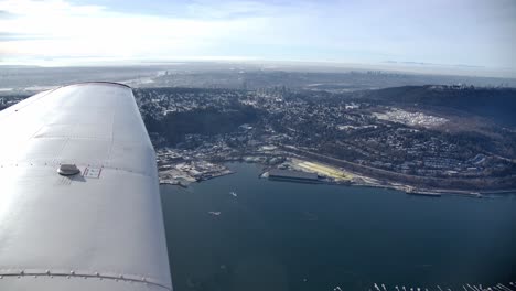 View-of-Small-Airplane-Wing-Flying-over-Port-Moody,-BC---Sunny-Day