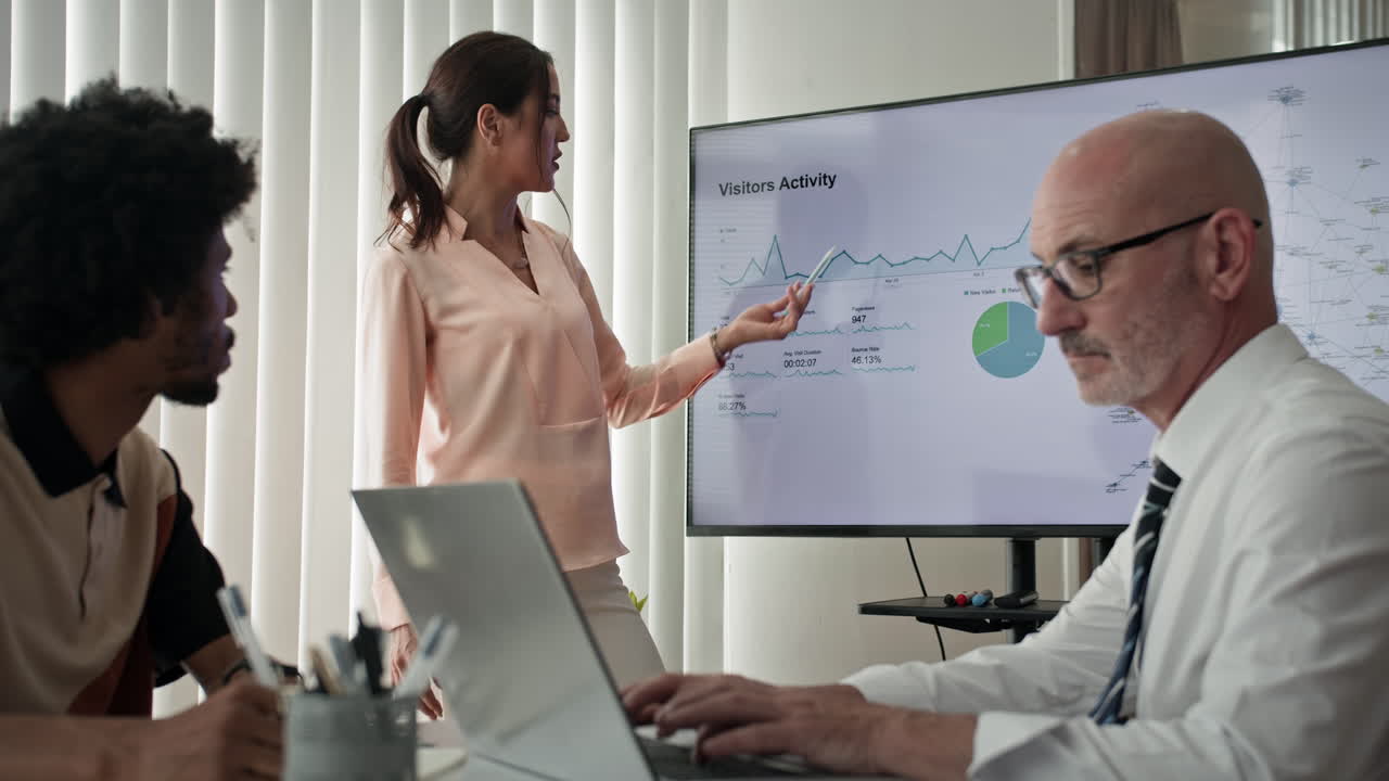 Employees Listening to Female Analyst Giving Presentation at Office