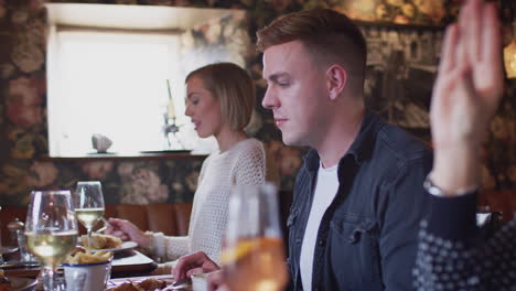 group of people eating in restaurant of busy traditional english pub