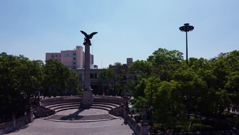 shot of lateral monument ending in the flag of mexico in aguascalientes