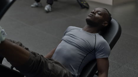 man doing leg press exercise in gym