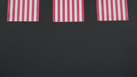 Video-of-three-flags-of-united-states-of-america-on-grey-background