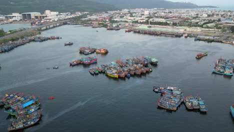 vietnamese fishing trawlers cluster together in the safety of danang harbour while drone circles