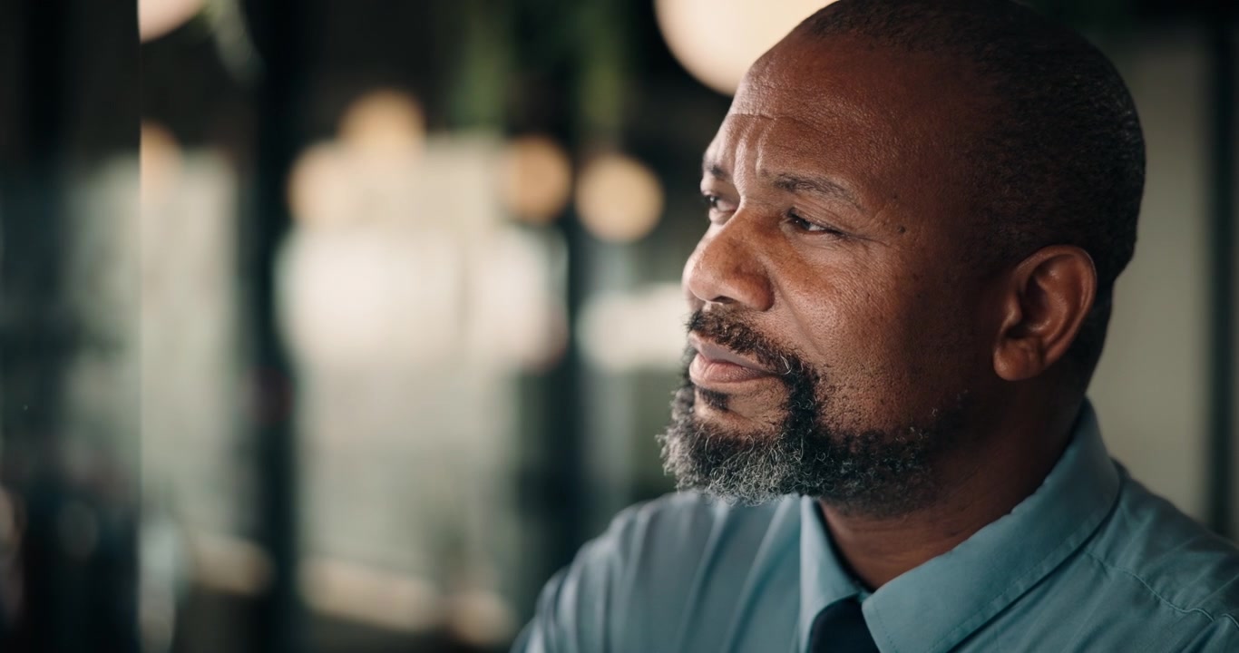 Thoughtful Mature Businessman Looking Away in Modern Office