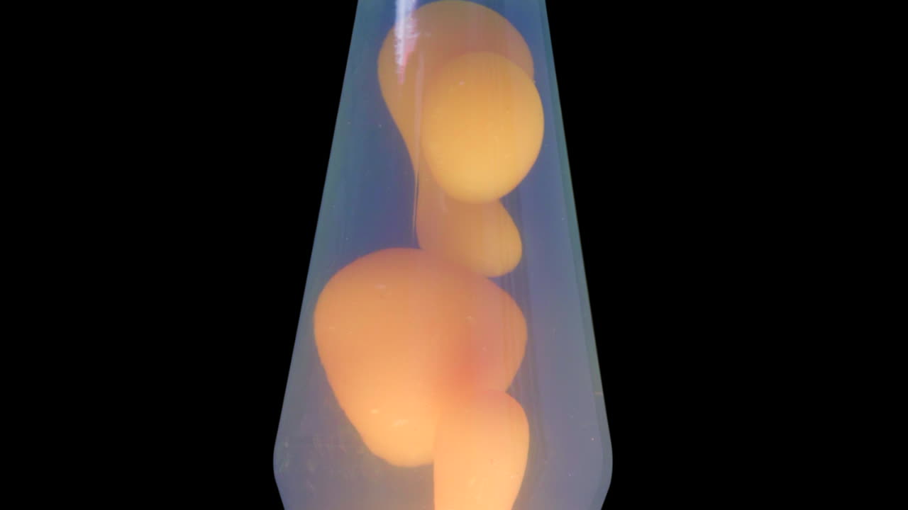 Close Up of Orange and Blue Lava Lamp on Black Alpha Background