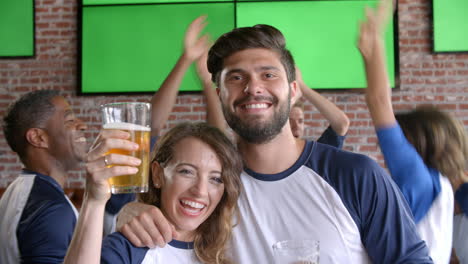 couple watching game in sports bar on screens shot on r3d