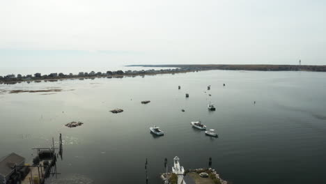 Flying-over-Biddeford-Pool-Maine,-quiet-waters-and-anchored-boats
