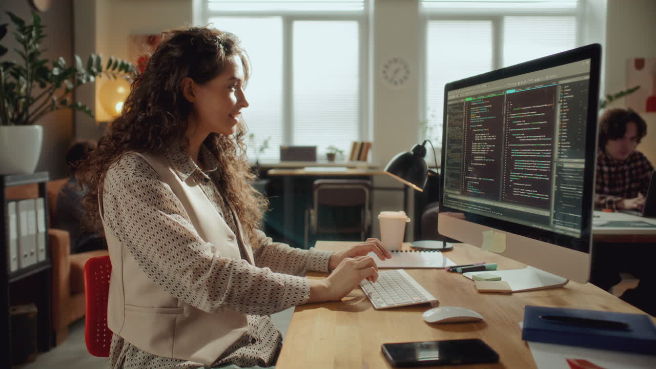 Female Software Developer Coding on Computer at Office Desk