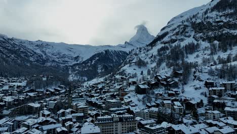 slow drone flyover of zermatt switzerland and the matterhorn during winter