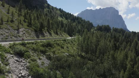 cyclist high speed on a beautiful road in the green nature mountain area, italy