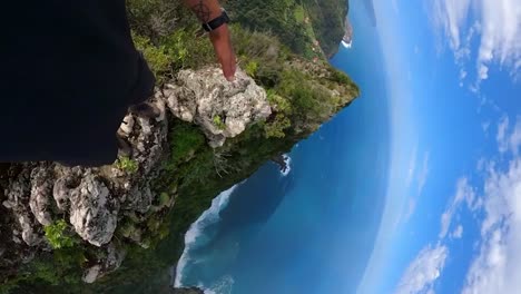 Vertical-360-footage-of-a-man-hiking-carefully-on-the-edge-of-Pico-do-Alto-in-Madeira