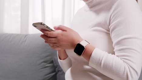 detail of female hands checking notifications on cell phone