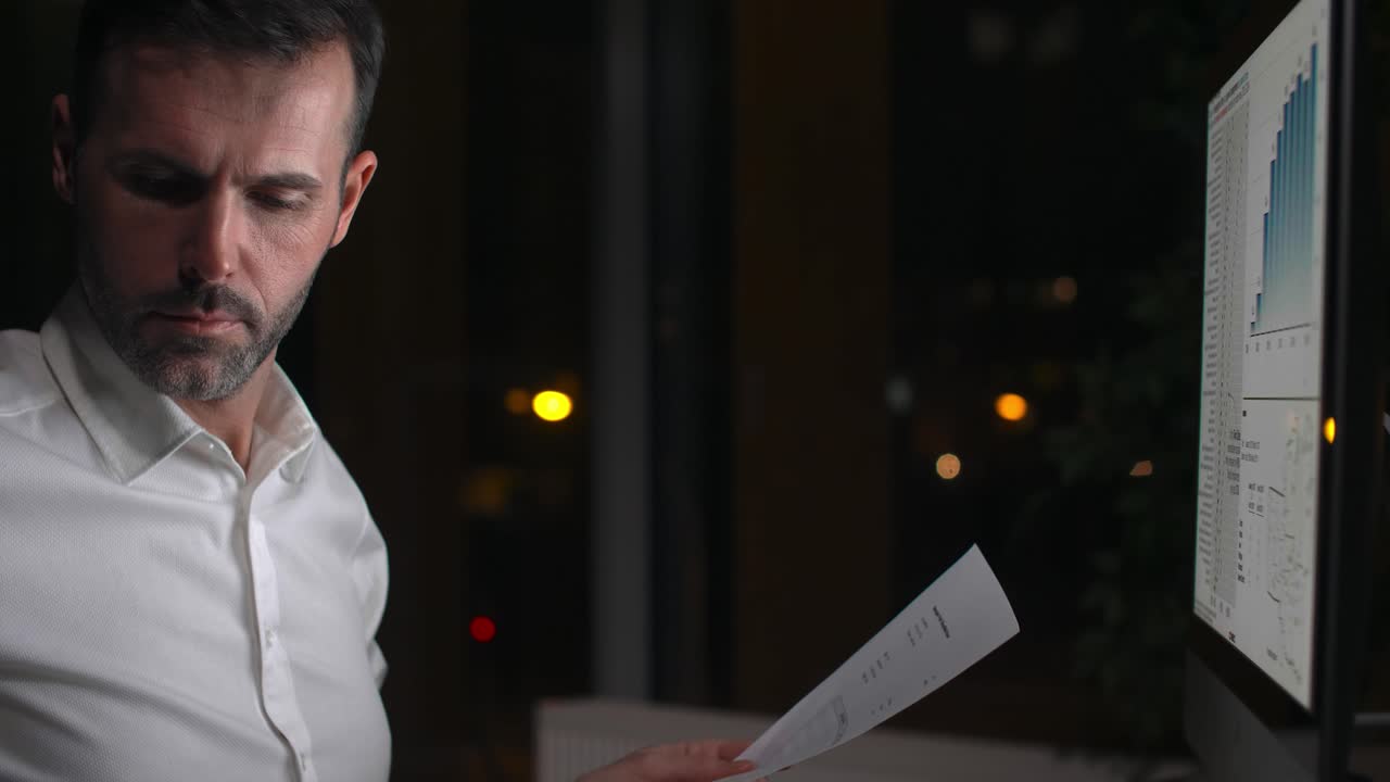 Focused man working with technology at night