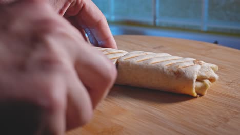 hands cutting anabolic tuna wrap