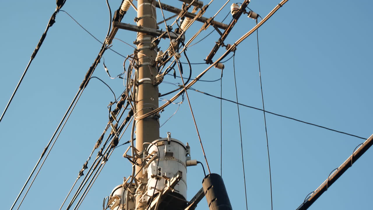 Electrical net of poles against the blue sky