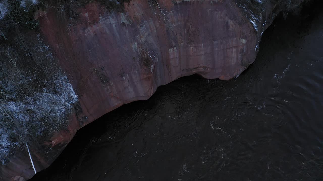 Take off of cliff near Gauja river in Latvia during winter
