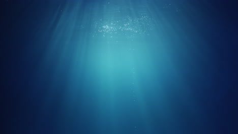 underwater sunlight beams shining from above coming through the deep crystal clear blue water causing a beautiful water lighting reflections curtain