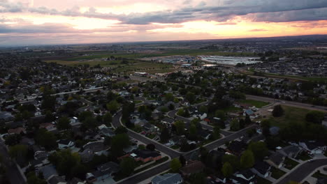 Vista-Aérea-Del-Paisaje-Sobre-Una-Zona-Verde-Suburbana,-Al-Atardecer