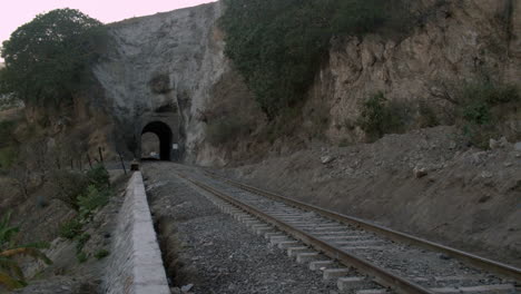 railroad tracks and tunnel alongside the country