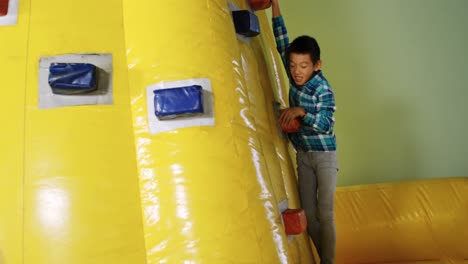 boy climbing bouncy castle 4k