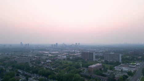 dense wildfire smoke causing low visibility and poor air quality in densely populated urban city centre