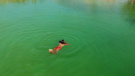 Amazing-drone-shot-of-a-model-swimming-in-a-salt-lake-with-greenishhues
