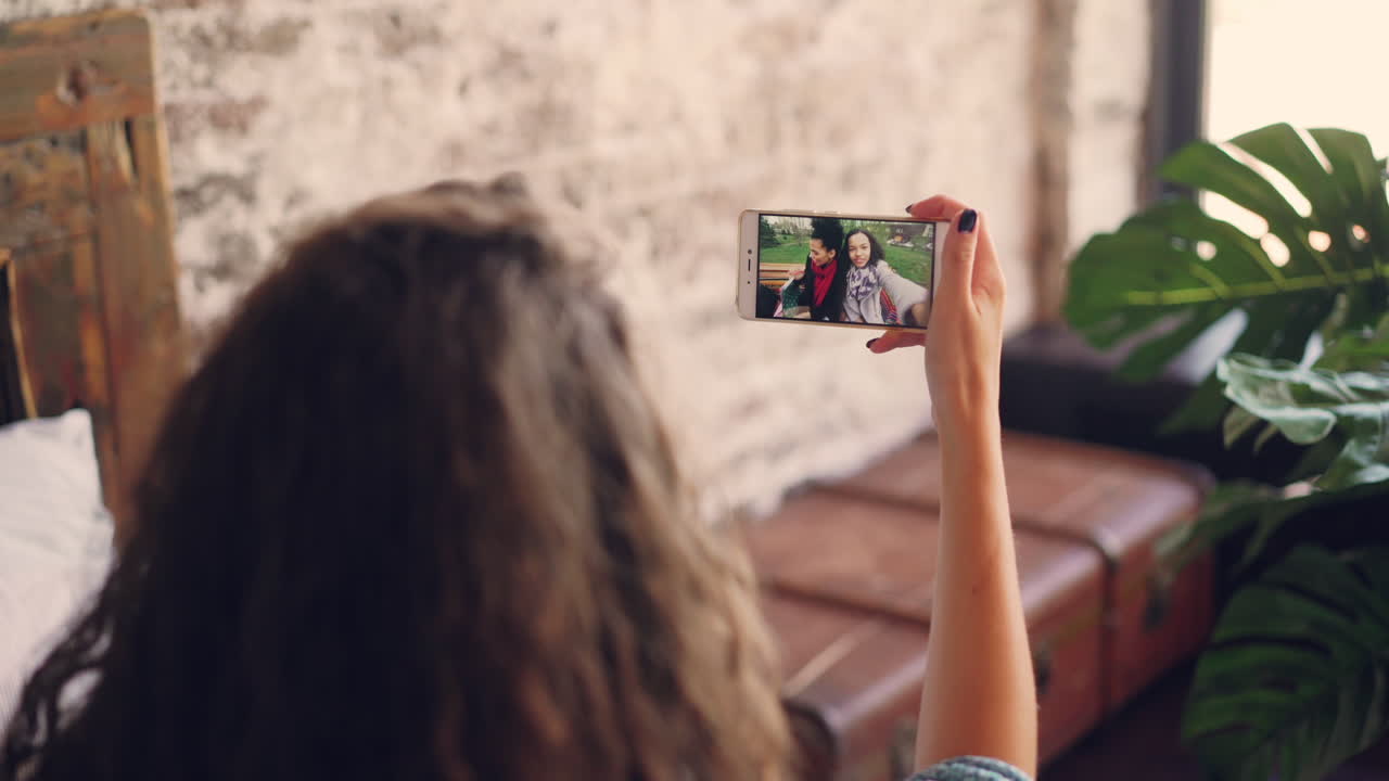 Woman taking selfie video call with friend