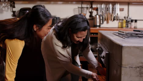 multiracial grandma and young woman baking together in kitchen, at home