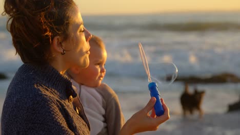 Mother-and-baby-boy-playing-with-bubble-wand-4k