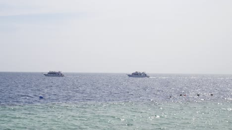 white ship yacht sails in blue water of the sea or ocean