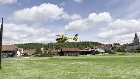 air ambulance helicopter landing on field to attend to an emergency, slow motion