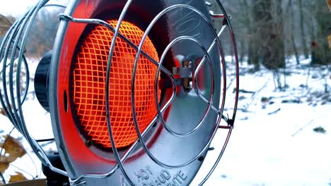 close up of a gas propane heater in the snow