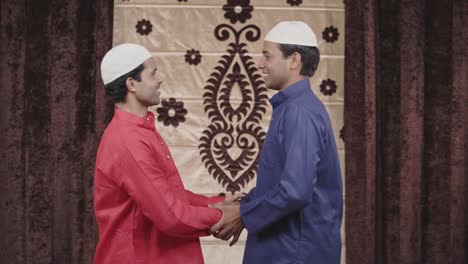 two indian muslim men hugging