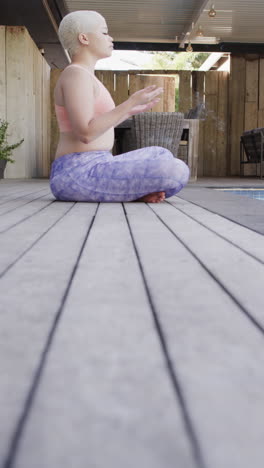vertical video of happy biracial woman meditating in slow motion