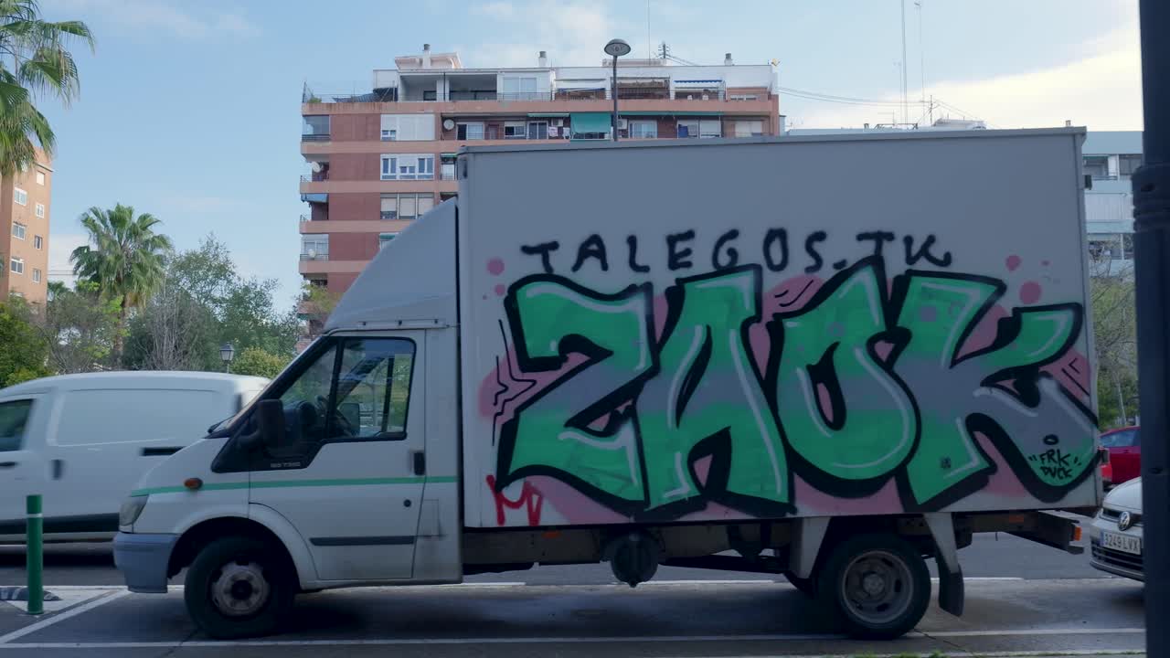 City Street Scene with Graffiti Truck and Cars