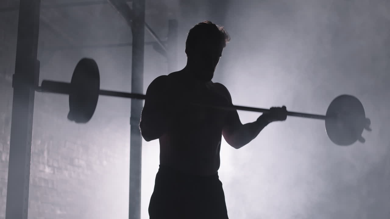 Silhouette of Male Powerlifter Lifting Barbell