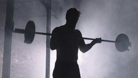 silhouette of male powerlifter lifting barbell