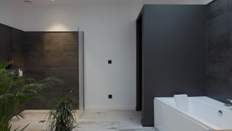 modern bathroom with sleek gray tiles, a minimalist bathtub, and indoor plants creating a serene and contemporary atmosphere