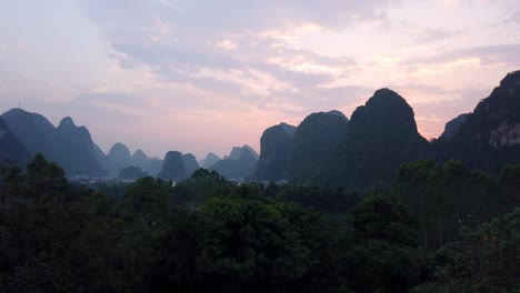 clip of the beautiful sunset over the green, lush and dense karst mountain landscape in yangshuo, guangxi province, china