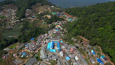 Stunning-slow-motion-drone-flight-over-rural-mountain-village-in-Thailand