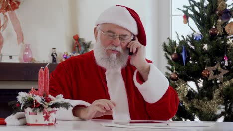 santa is talking on the phone